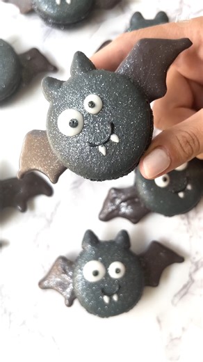 These adorable bat macarons with chocolate wings are sure to be a hit for any Halloween party! (These look scary delicious, Bella Bakes!) 🦇 See more creepy creations on #HalloweenWars, Sunday @ 9|8c! | Food Network