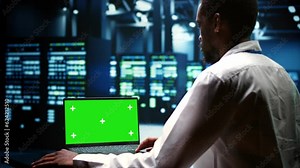 System administrator examining server rigs performance trends. Expert using green screen laptop to discover data center operational issues arising due to high CPU usage and insufficient memory
