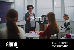 Female Educator in Computer Programming Class Presents Software Code on Smartboard, Engaging Students in Discussion. Concept STEM Education, Interactive Learning, and Innovation in Teaching Methods.