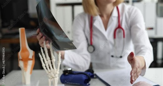 Patient with broken arm visits traumatologist and examines x-ray. Complications of limb immobilization with plaster concept