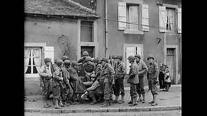 FRANCE - 1944 - US soldiers in Metz, France stand near Jeep and listen to the radio for the 1944 Election results.