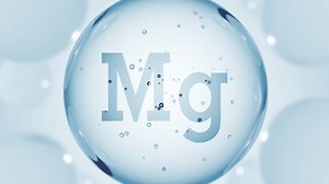 A blue glossy sphere with mineral Mg. Magnesium pill capsule. Abstract 3D bubble drop background