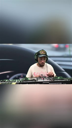 DJ mixing tracks with race cars in the background! #DJLife #MusicMix #RaceCar #Nightlife #Vibes