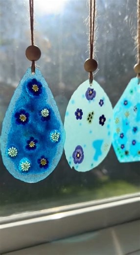 DIY Bioplastic Suncatchers Here’s a delightful way to brighten your home with the sun's warm glow and some love from nature. Ingredients: - Blue crayons (various shades including light blue, teal, navy) - Clear plastic sheets (laminating sheets or clear report covers) - Parchment paper - Pressed flowers (fully dried) - Twine or string - Wooden beads (optional) Directions: 1. Start by peeling the paper from your crayons. Use a sharpener or a knife to shave the crayons into thin flakes, mixing sha