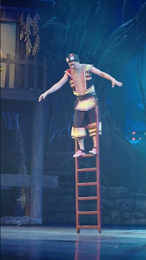 Acrobat performs high ladder balancing act during folk stage show in Hunan, China