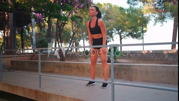 Fit woman doing push-ups in park. Female athlete performing incline push-ups on elevated surface outdoors, strengthening chest, shoulders, and triceps. Sportswoman during outdoor upper body workout.