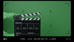 Movie Clapper board clapped by Hands on green screen camera...