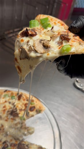 November’s here, and so is the Philly Cheesesteak Pizza! Piled high with steak, peppers, and ooey-gooey cheese. You know you wanna taste that cheese pull! | Geno's Giant Slice