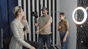 Beautiful Model Posing for a Video Clip, Cameraman Filming Her.