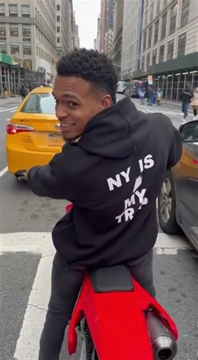 YN rides dirtbike thru busy midtown street