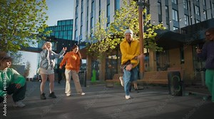 Slow Motion: Young And Athletic B-Boy Breakdancing To Break Beats On The City Street Among Modern Buildings In Circle Of Friends. Group Of Fashionable People Supporting, Live Streaming Via Smartphone.