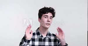 A curly-haired Caucasian man on a white background. With an unmatched energy, he captivates the camera, engaging viewers through his expressive gestures and animated conversation.