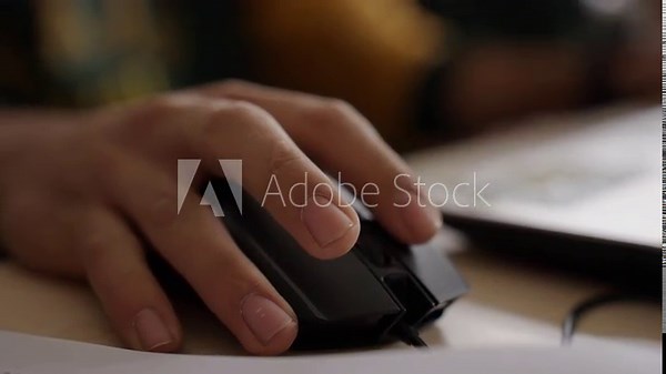 Young Male Hand Using a Computer Mouse in a Study Environment