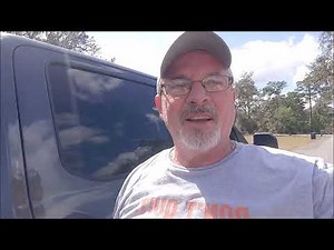 Transporting a standup freezer in an open trailer. Alone