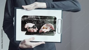 Footage computer graphics and double exposure. A woman holds a tablet with a sheet of paper on which her hands hold chess pieces. Psychological tests and analogies