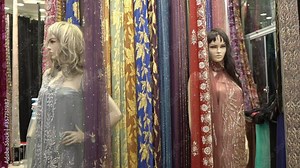 Fabric and dress shop in traditional arabic oriental bazaar marketplace, close up slowmotion