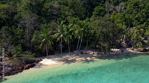 Koh Wai Island Trat Thailand with wooden bamboo hut bungalow on the beach with palm trees and a turqouse colored ocean. a young couple of men and woman on a tropical beach at Koh Wai Island