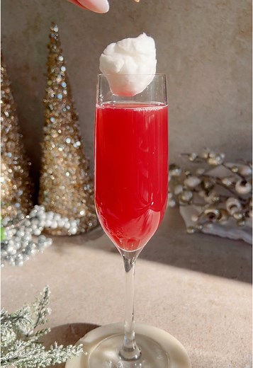 The viral glitter ball drop, but make it hangover-free with a little buzz thanks to @Cycling Frog. ✨. These glitter balls are amazing to put out at your New Year’s Eve parties! ⏰ Instructions: • Pour 5 oz of Cycling Frog Seltzer (I used Black Cherry) into a champagne flute • Sprinkle edible glitter into cotton candy and roll into a ball. Make sure your hands are totally dry! • You can pre-roll the cotton candy balls and keep in a small bowl for guests to grab at NYE Hope everyone has a safe and