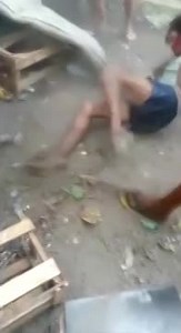 Faction members try to strangle a woman with a scarf, she fights back and ends up being shot,Brazil