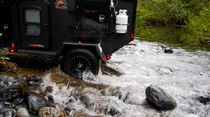 Off-road - no problem. Built with a 50º departure angle, Timbren 3500 HD suspension, 4" lift, and 12" electric brakes! Visit our website to view our well-equipped all-metal trailers. | Off Grid Trailers