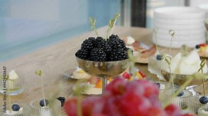 Close-up of different types of fruits, cheese and canapes on a buffet table in a restaurant.