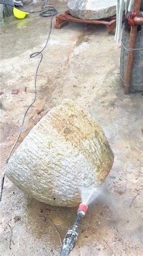 High-Pressure Washing an Old, Mossy Millstone
