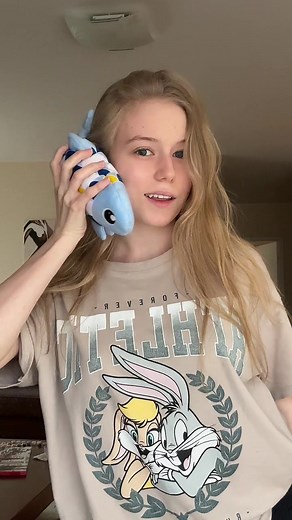 Young Woman Talks on Phone with Plush Bunny Toy