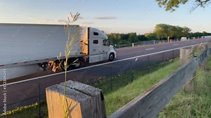 vehicles driving past camera on highway interstate rest stop
