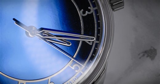 The @sartorybillard SB04 Blue. The round 40mm case is crafted from an ingot of stainless steel, with brushed, polished and matte blasted surface finishings, and features a gently domed box-sided sapphire crystal which creates a distorted refraction around its edge. Classical in its shape, each case is produced singularly, and its lugs flow from the rounded contour of the case, while the squat signed crown neatly hugs the waist of the watch. Beneath the sapphire glass, the dial is immediately str
