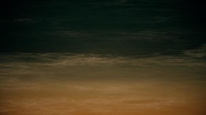 Beach at night animation - tranquil sandy beach and gentle dark ocean waves. Looping, full hd motion background.