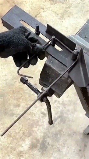 bending a thin copper wire precisely using a professional manual metal bending tool in a workshop