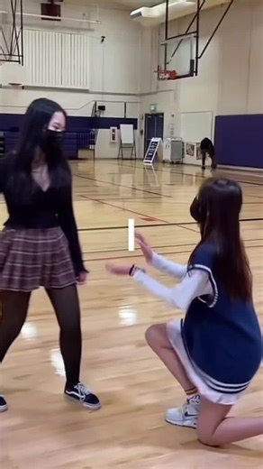 Cheerleading Dance Move Mishap in a Gymnasium