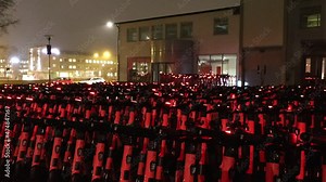 Stockholm, Sweden A large collection of Voi scooters in the parking lot of its local headquarters.