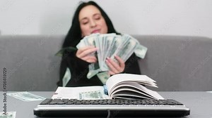 Hands on a digital tablet keyboard close-up of a girl working in an office remotely typing text and counting money, woman using a notepad Distance learning online education and work