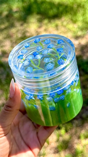 Resinate By Chanel on Instagram: "Fly through the skies 🪽 or breathe underwater 🌊 — which one are you choosing, besties?! Drop your answer in the comments because I need to know 👀✨ For today’s tutorial, I’m showing you how I made this dreamy flower jar 🌼💙 The jar features delicate blue baby’s breath flowers suspended in crystal clear resin from @letsresin ✨ The lid and top half are fully clear for that glassy, underwater look, while the base is a hand-mixed grass green resin that I blended 
