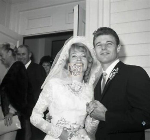 "Circa 1961, actor David Nelson and his first wife, actress June Blair, were photographed on their wedding day at the Church of the Hills in California, radiating youthful joy and elegance. Nelson, best known as part of the beloved television series The Adventures of Ozzie and Harriet, looked dashing and proud, while Blair, graceful and radiant in her bridal gown, shone with beauty and charm. Their ceremony reflected warmth and celebration, shared with family and friends in a picturesque setting
