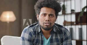 Video call with young black man. Businessman talking to camera gesticulating smiles making conference business call. Confident job applicant doing video chat, video conference for distance interview.