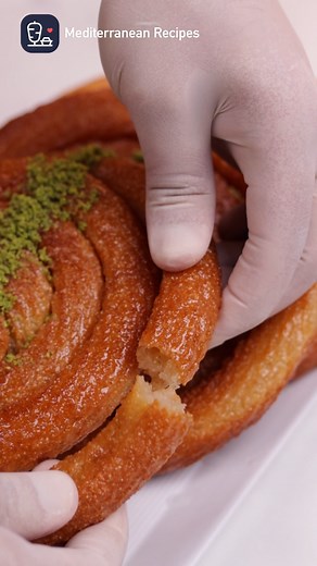 Imagine sinking your teeth into a piece of Mushabak Sweet. It’s a sweet, crispy, golden delight that whispers the secrets of Middeterranean cuisine. As you take that first bite, the symphony of flavors unfolds. The gentle crunch, the sweet embrace of sugar syrup, the hint of aromatic spices – it’s a journey for your senses. 🌟🍰😋 Preparation Time: 1 hour Yields: 6 servings Ingredients: 3 cups coarse semolina 1/2 cup all-purpose flour 1/4 cup sugar 1/4 cup vegetable oil 1 tablespoon instant yeas