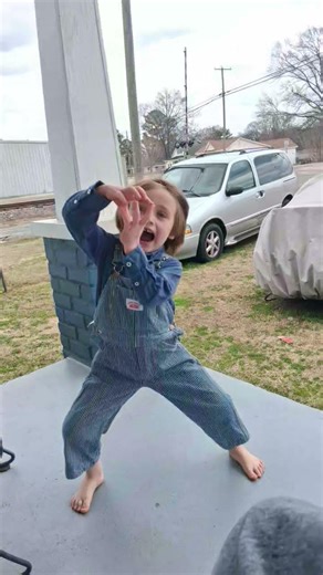 Andersyn waiting on the porch for the train to come so the train guy see his conductor outfit#train