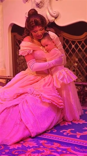 Little Girl Gets Hug from Belle