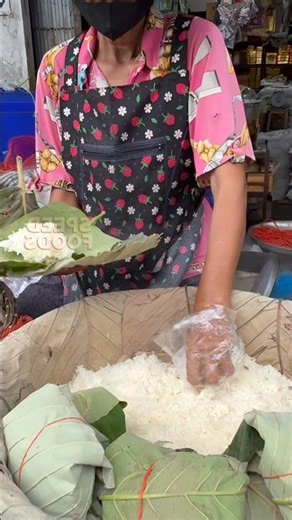 Sticky rice wrapped in banana leaves, a large portion that's enough for the whole family to eat. ...