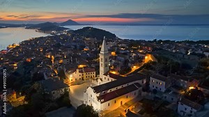 Mali Losinj old town after sunset with city lights. Aerial evening view of bays and islands of Croatia. Losinj and Cres islands - great summer sea travel destination