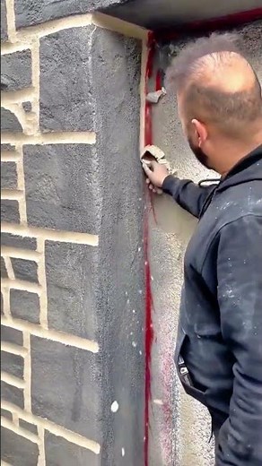 Wall painting process creating stone texture with roller brush