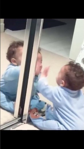 Cute baby kiss the mirror