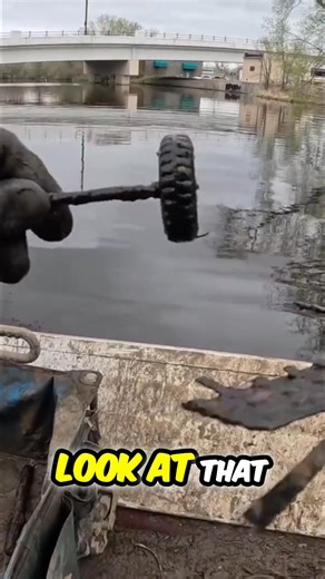 A magnet fisher's haul starts with the mundane: a box fan and a coat hanger. Then, a rusty toy car wheel emerges, followed by an unidentifiable white object lurking in the depths. What could it be? #MagnetFishing #UrbanExploration #TreasureHunt #CanalFinds | The Fisher Magnet Fishing