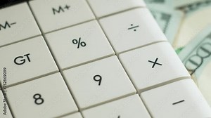 Calculator and dollars bills close up. Concept of paying taxes and filing tax return. Business, inflation and deflation concept. Finance money background. Calculate costs using calculator