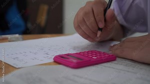 students hand testing doing examination with calculator and pencil drawing selected choice on answer sheets in school exam at college, 4K