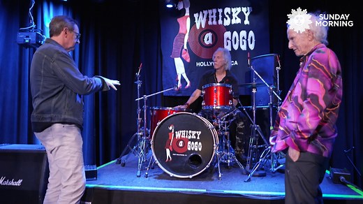 Sixty years after they formed in Venice, California, The Doors are being honored with a new book, “Night Divides the Day: The Doors Anthology.” Anthony Mason revisits the band’s roots with guitarist Robby Krieger and drummer John Densmore—the group’s two surviving members—tracing the rise of the legendary quartet whose raw, poetic energy helped shape rock history. | CBS Sunday Morning