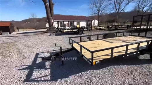 NEW 2026 Mastiff Brand HEAVY DUTY Mastiff Utility Landscape Trailer with Ramp Gate. Equipped with 3500lb EZ lube Axle, UPGRADE LED LIGHTS 4" channel fully wrap around tongue, 4' Reinforced Ramp Gate FOLDS INTO BED AND IS REMOVABLE, UPGRADE 2" Coupler, 2k A-Frame Set Back Jack, Pressure treated wood floor, Spare Tire Mount & 15" RADIAL TIRES! #AmericanMade #mastifftrailers #dgtrailersales #dgtrailers #utilitytrailer | DG Trailer Sales