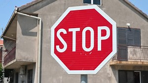 Red STOP traffic sign on the road. Street sign in city. Stop sign at the intersection of streets. Stock Video